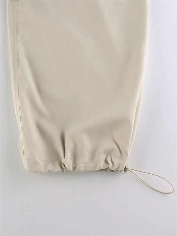 Light colored baggy parachute cargo pants with drawstring and low waist